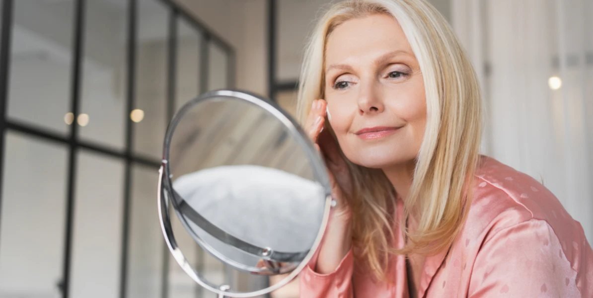 Client assessing forehead lines in a mirror